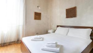 ミラノにあるItalianway-Pastrengo 11のベッドルーム1室(白いベッド1台、タオル付)