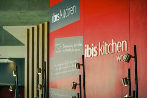a wall with the words dogs kitchen work on it at Ibis Rabat Agdal in Rabat