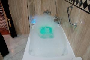 a bath tub filled with lots of blue water at Luxury Apartment Plus Ultra in Seville +45 photos