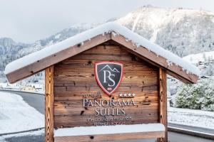 a sign on a wooden building with snow on it at AvenidA Panorama Suites in Kaprun +159 photos