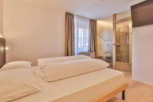 Voodi või voodid majutusasutuse Belvenu Boutique Hotel toas