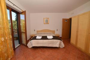 a bedroom with a bed and a large window at La Locanda di Campagna in Agropoli