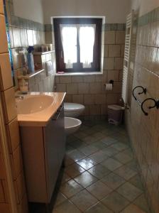 a bathroom with a sink and a toilet and a window at Bed & Breakfast Ca' di Vissai in Arnasco +39 photos