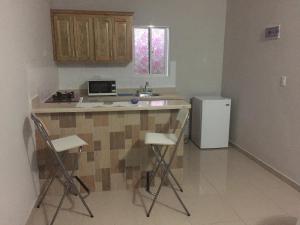 a kitchen with a counter and a refrigerator at Blue Acuarela in Cabrera