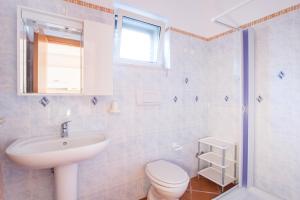 a bathroom with a sink and a toilet and a window at Villa Calma in Vieste +89 photos