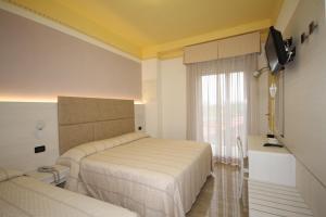Postel nebo postele na pokoji v ubytování Hotel Grado + 37 fotografií