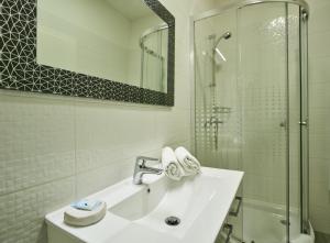 a white bathroom with a sink and a shower at Stars of Zagreb Apartments in Zagreb +24 photos
