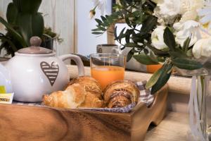 a tray of pastries and a glass of orange juice at Hotel Soleluna in Piano di Sorrento