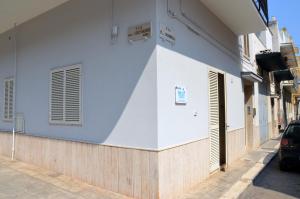 a blue and white building with a car parked on a street at B&B A Pochi Passi in Polignano a Mare +29 photos