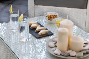 a glass table with a plate of food and candles at Hotel Soleluna in Piano di Sorrento