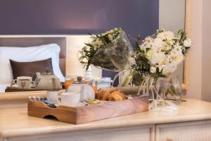 a tray of food and flowers on top of a table at Hotel Soleluna in Piano di Sorrento