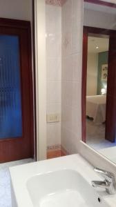 a bathroom with a white sink and a mirror at Bacanal Apartment in Venice