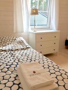 a bedroom with a bed with two towels on it at 8 Sosen Pobierowo in Pobierowo