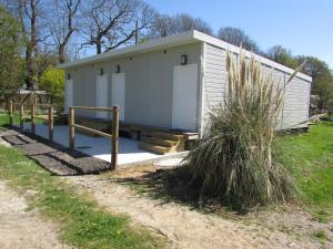 a small white building with a ramp and a fence at Etretat's Motel in Étretat