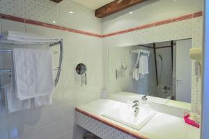 a white bathroom with a sink and a mirror at Villa Ric in Saint-Céré +37 photos