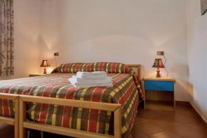 Postel nebo postele na pokoji v ubytování Agriturismo Lo Strettoio