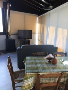 a living room with a table and a couch at Xenios Guesthouse in Koilani
