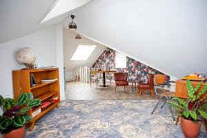 an attic living room with a table and chairs at B&B Ootmarsum in Ootmarsum