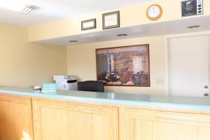 an office with a counter and a clock on the wall at Budget Inn Flagstaff in Flagstaff