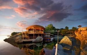 a group of boats docked in a river with a sky at Atliman Beach Apartment 1 in Kiten