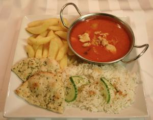 a plate of food with rice and a pot of soup at The Tanners Arms in Devynock