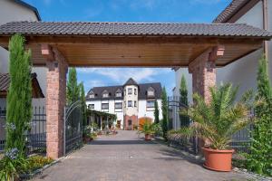 a brick archway leading to a building with houses at Landhotel Hopp Garni in Heßheim