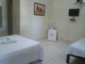 a hospital room with a bed and a fan at Pousada Central in São Benedito +48 photos