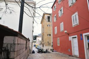 an alley with red buildings on a city street at Apartment Boris in Zadar