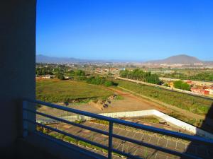 a balcony with a view of a field and a city at Departamento Marina Sol III in Coquimbo