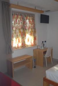 TV a/nebo společenská místnost v ubytování B&B Alciliegio