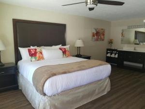 a bedroom with a large bed with pillows at The Waldport Inn in Waldport