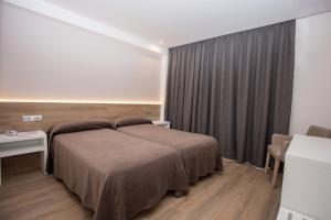 Postel nebo postele na pokoji v ubytování Hotel Perla