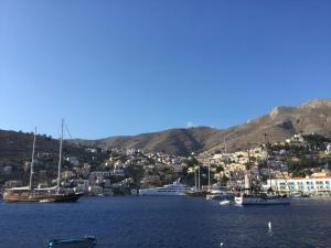 a group of boats in a body of water at Nikolitsi Studios in Symi