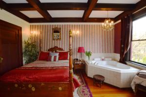 a bedroom with a bed and a bath tub at Marketa's Bed and Breakfast in Victoria