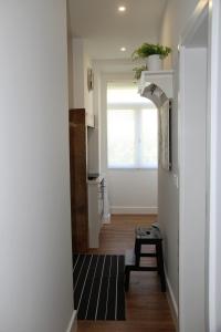 a hallway with a kitchen with a window and a table at Lisboa 1912 - Alojamento de Charme in Lisbon