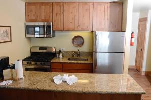 a kitchen with a refrigerator, stove, sink and microwave at Northstar California Resort in Truckee