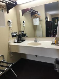 a bathroom with a sink and a mirror at Americas Best Value Inn & Suites - Little Rock - Maumelle in Maumelle