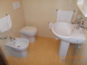 a bathroom with a white sink and a toilet at A Casa Di Monia in Felline