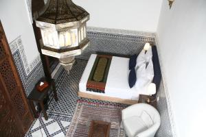 a small bedroom with a bed and a toilet at Riad Batchisarai in Fez