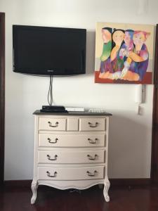 a dresser with a flat screen tv on top of it at Shabby Chic Bairro Alto 3 in Lisbon