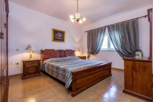 a bedroom with a large bed and a window at Holiday Home Vesna in Ližnjan