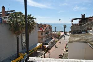 a view of a city street with buildings and palm trees at Set Arat Motel & Pansiyon in Akcay