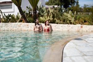 two women are standing in a swimming pool at Echi di Puglia in Polignano a Mare