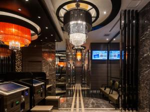 a lobby of a hotel with a chandelier at APA Hotel - Higashishinjuku Kabukicho Higashi in Tokyo