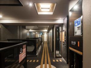 a hallway with a large mirror and a stairway at APA Hotel - Higashishinjuku Kabukicho Higashi in Tokyo