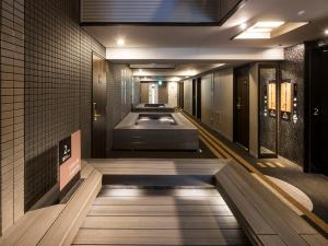an empty room with a stairway leading to an elevator at APA Hotel - Higashishinjuku Kabukicho Higashi in Tokyo