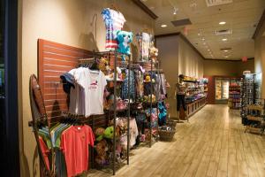 a store aisle with a rack of clothes and merchandise at Tahiti Village Resort & Spa in Las Vegas