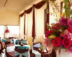 a room with a bouquet of flowers on a table at Tahiti Village Resort & Spa in Las Vegas