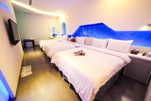 Postel nebo postele na pokoji v ubytování Galaxia Business Hotel