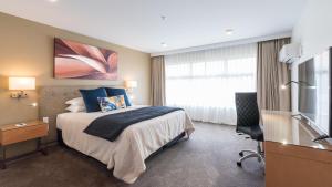 a hotel room with a bed and a window at Distinction Hamilton Hotel & Conference Centre in Hamilton